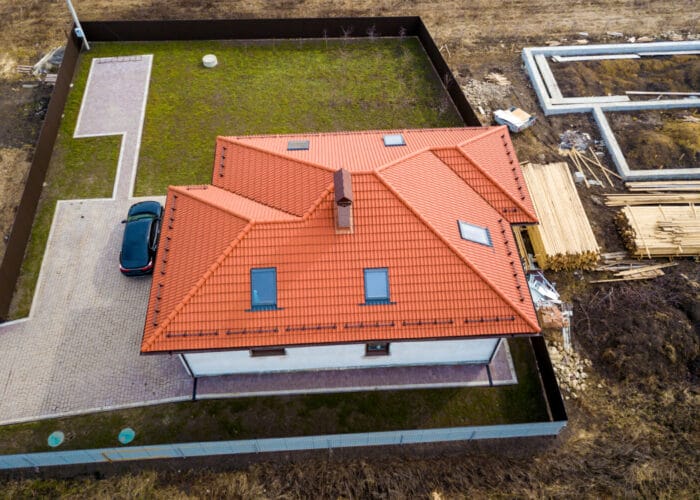 house-metal-shingle-roof-with-attic-windows-black-car house-metal-shingle-roof-with-attic-windows-black-car