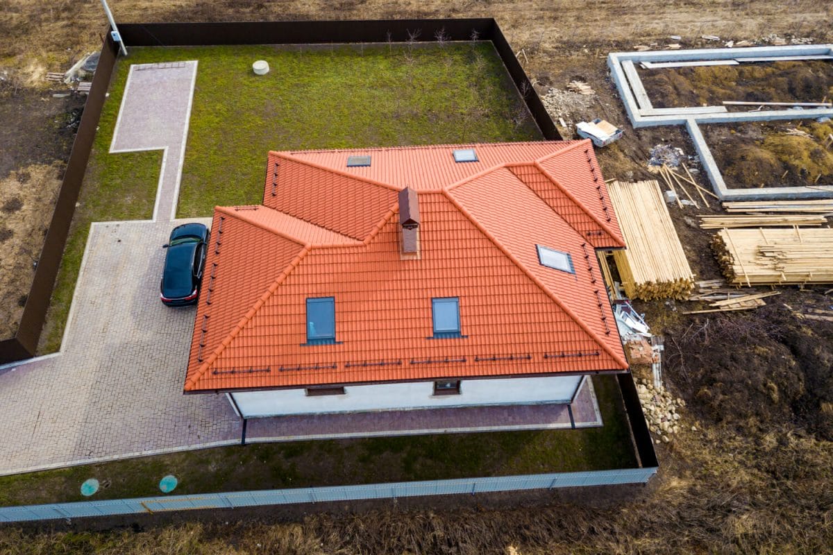 house-metal-shingle-roof-with-attic-windows-black-car house-metal-shingle-roof-with-attic-windows-black-car