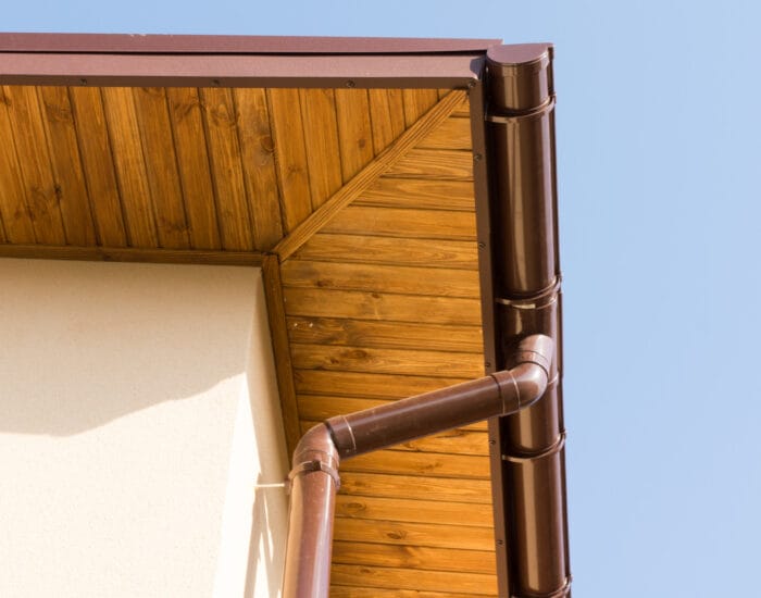 newly-installed-guttering-drainpipe-wooden-eaves-new-build-house-construction newly-installed-guttering-drainpipe-wooden-eaves-new-build-house-construction